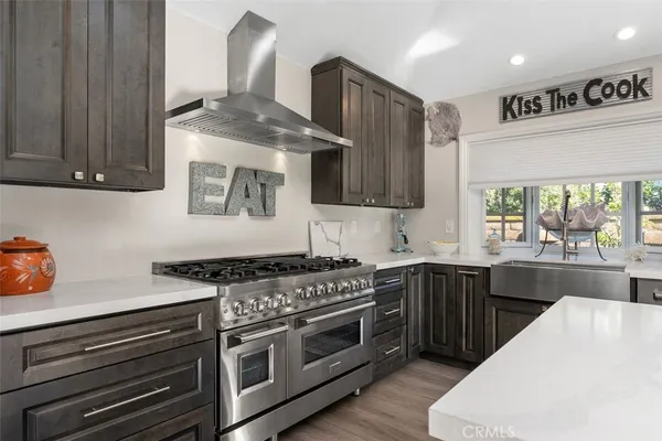 a kitchen with stainless steel appliances granite countertop a stove a sink and a microwave