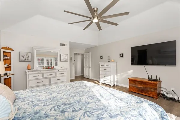 a bedroom with furniture and a flat screen tv