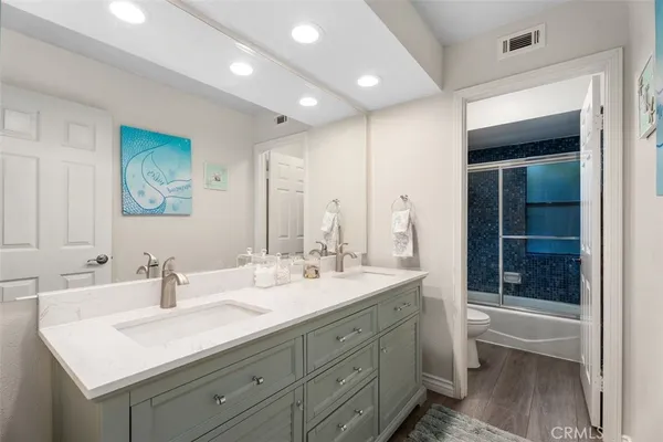 a bathroom with a double vanity sink mirror and double