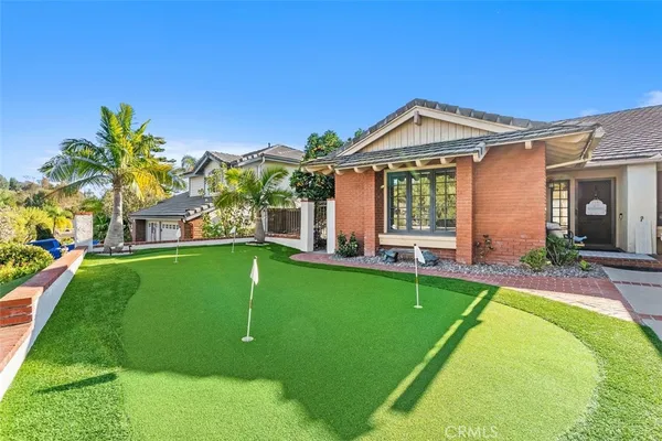 a view of a house with a backyard