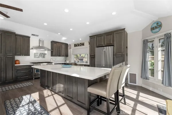 a large kitchen with kitchen island a dining table and chairs