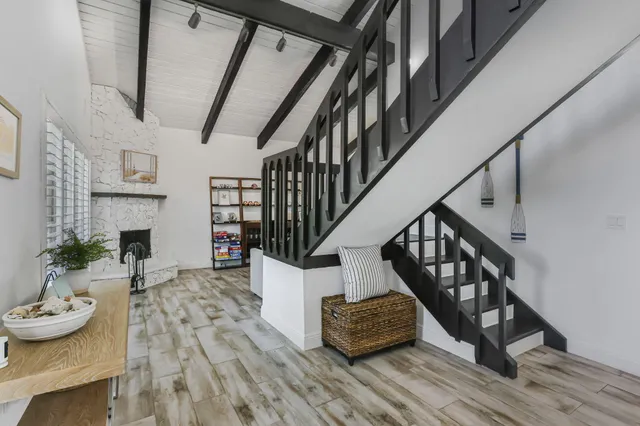 a bathroom with a granite countertop sink a mirror and shower