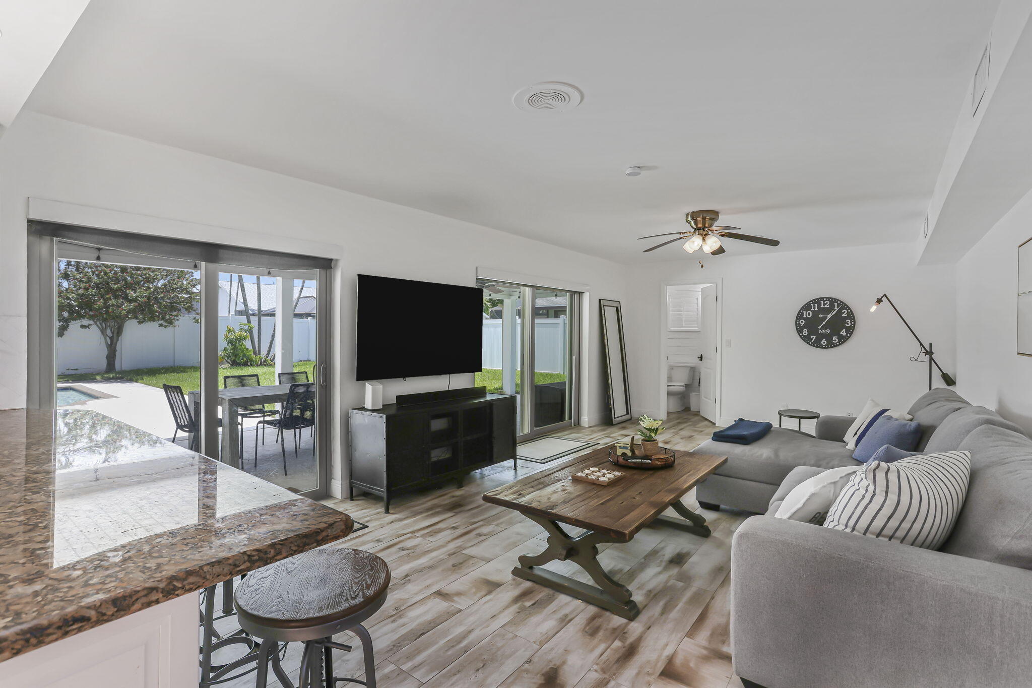 1260 Northwest 15th Street Boca Raton, FL 33486 - Photo 12 of 52 a living room with furniture flat screen tv and a large window