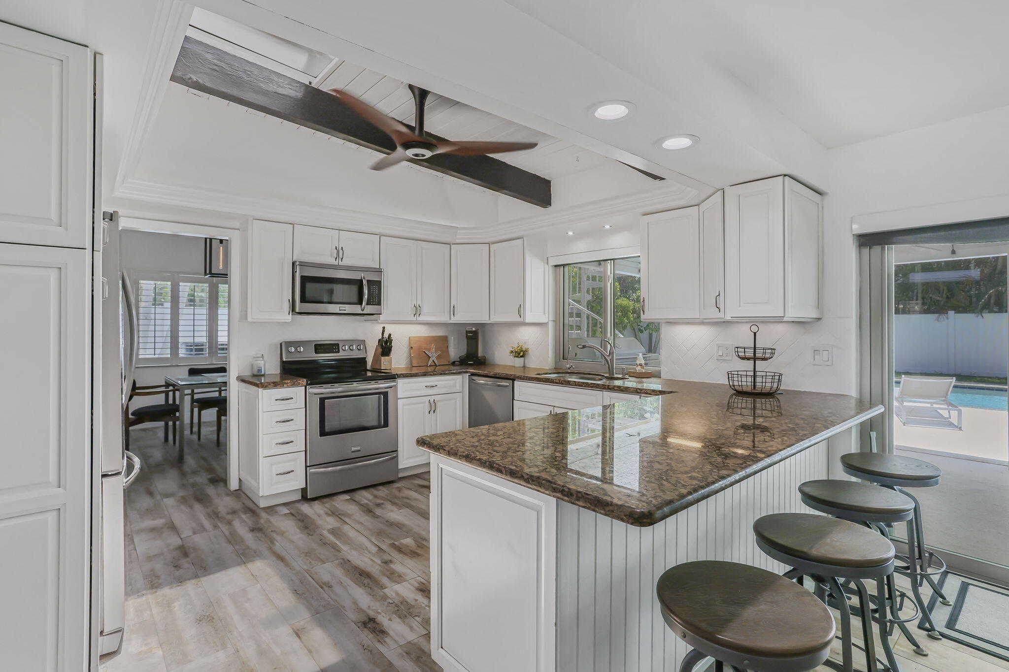 1260 Northwest 15th Street Boca Raton, FL 33486 - Photo 13 of 52 a large kitchen with granite countertop lots of counter top space and stainless steel appliances