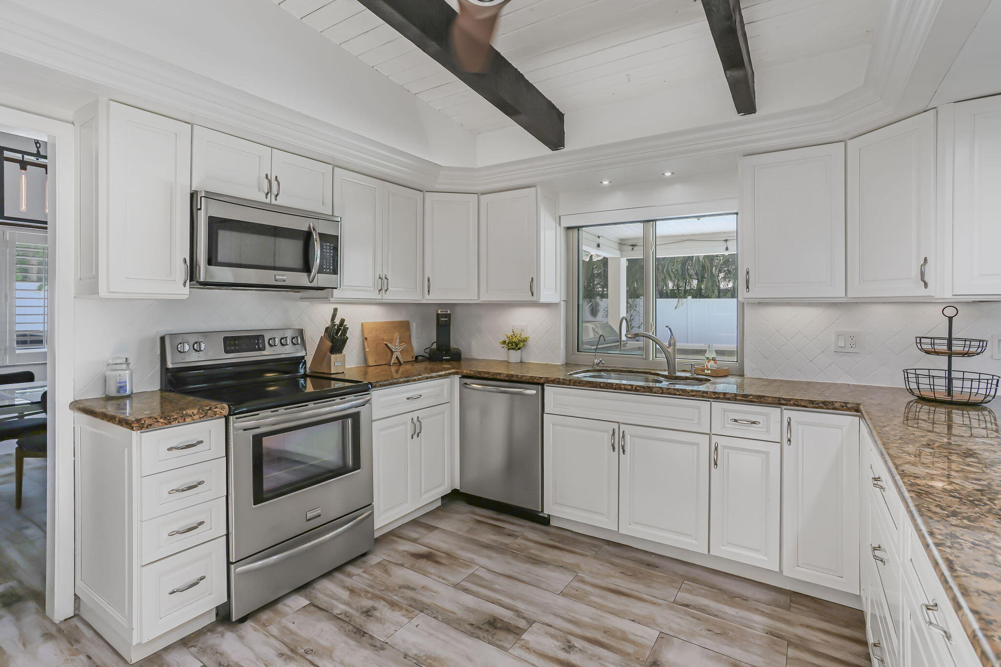 1260 Northwest 15th Street Boca Raton, FL 33486 - Photo 15 of 52 a kitchen with granite countertop cabinets stainless steel appliances and a sink