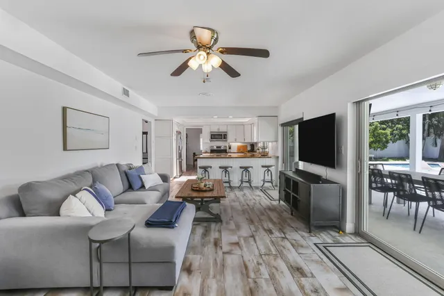 a bedroom with a bed and a flat tv screen on dresser