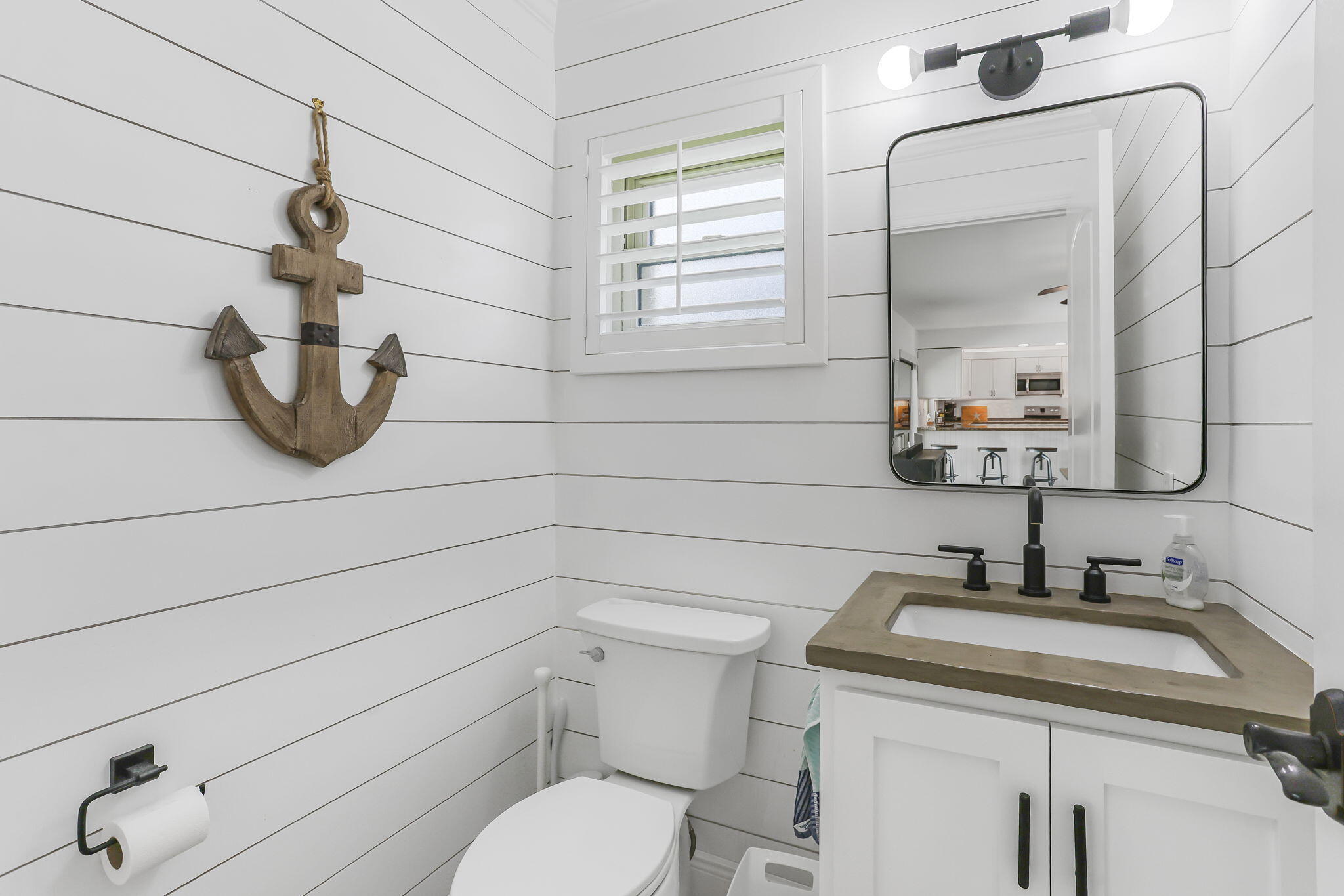 1260 Northwest 15th Street Boca Raton, FL 33486 - Photo 20 of 52 a bathroom with a toilet sink and mirror
