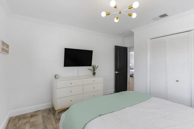 a dining room with furniture and a large window