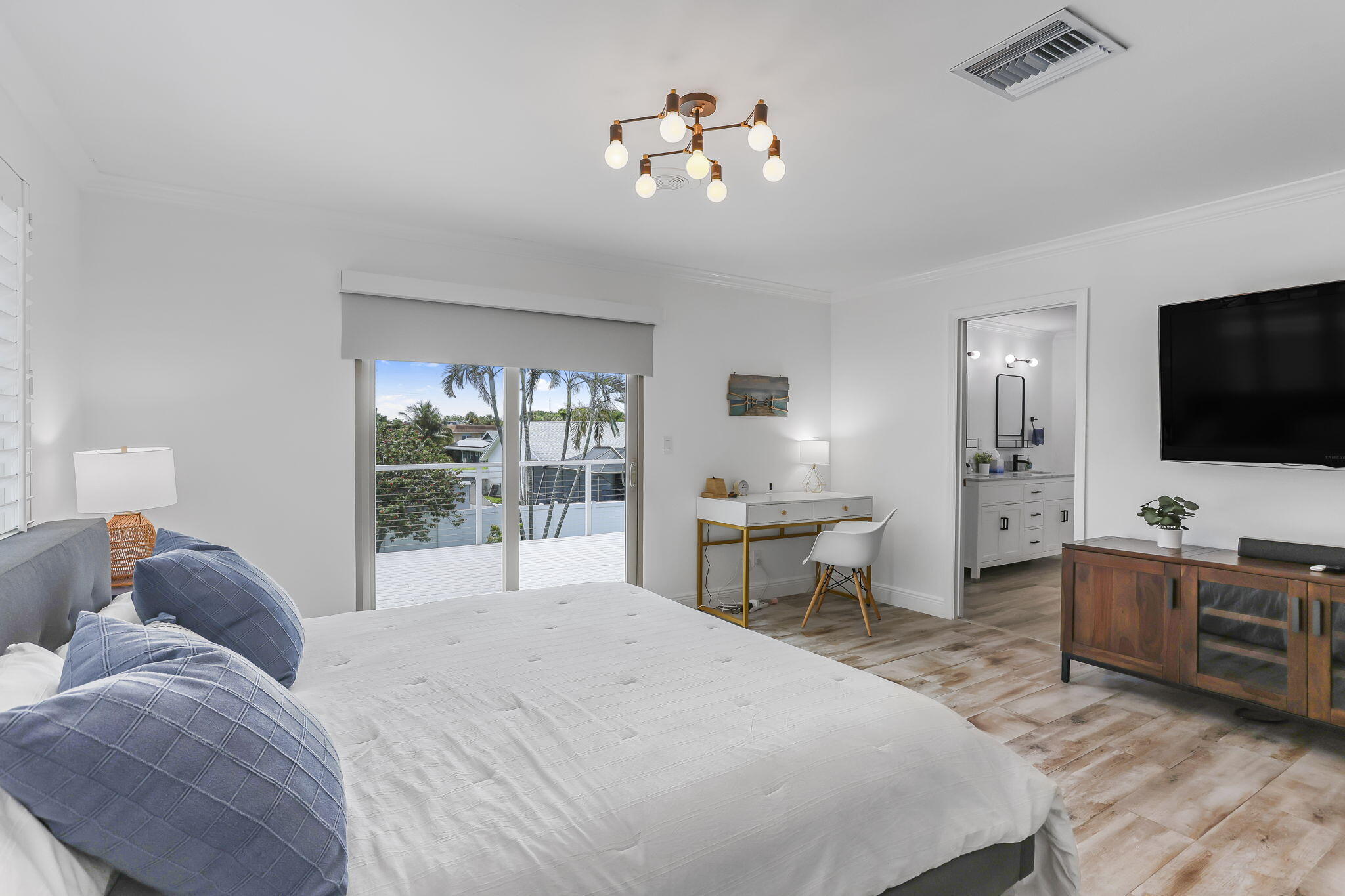 1260 Northwest 15th Street Boca Raton, FL 33486 - Photo 28 of 52 a bedroom with a bed and a flat screen tv