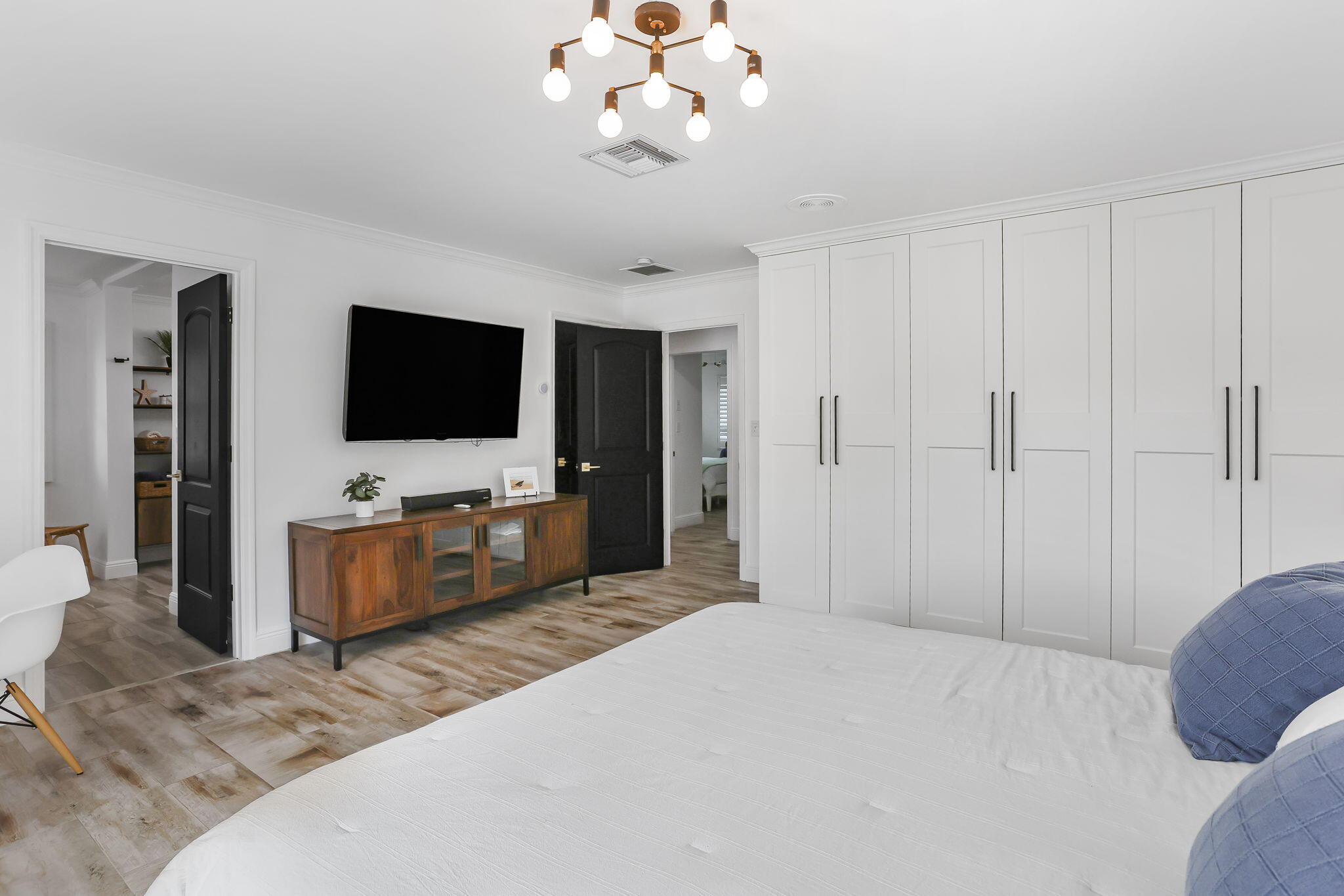 1260 Northwest 15th Street Boca Raton, FL 33486 - Photo 29 of 52 a spacious bedroom with a bed and a flat screen tv