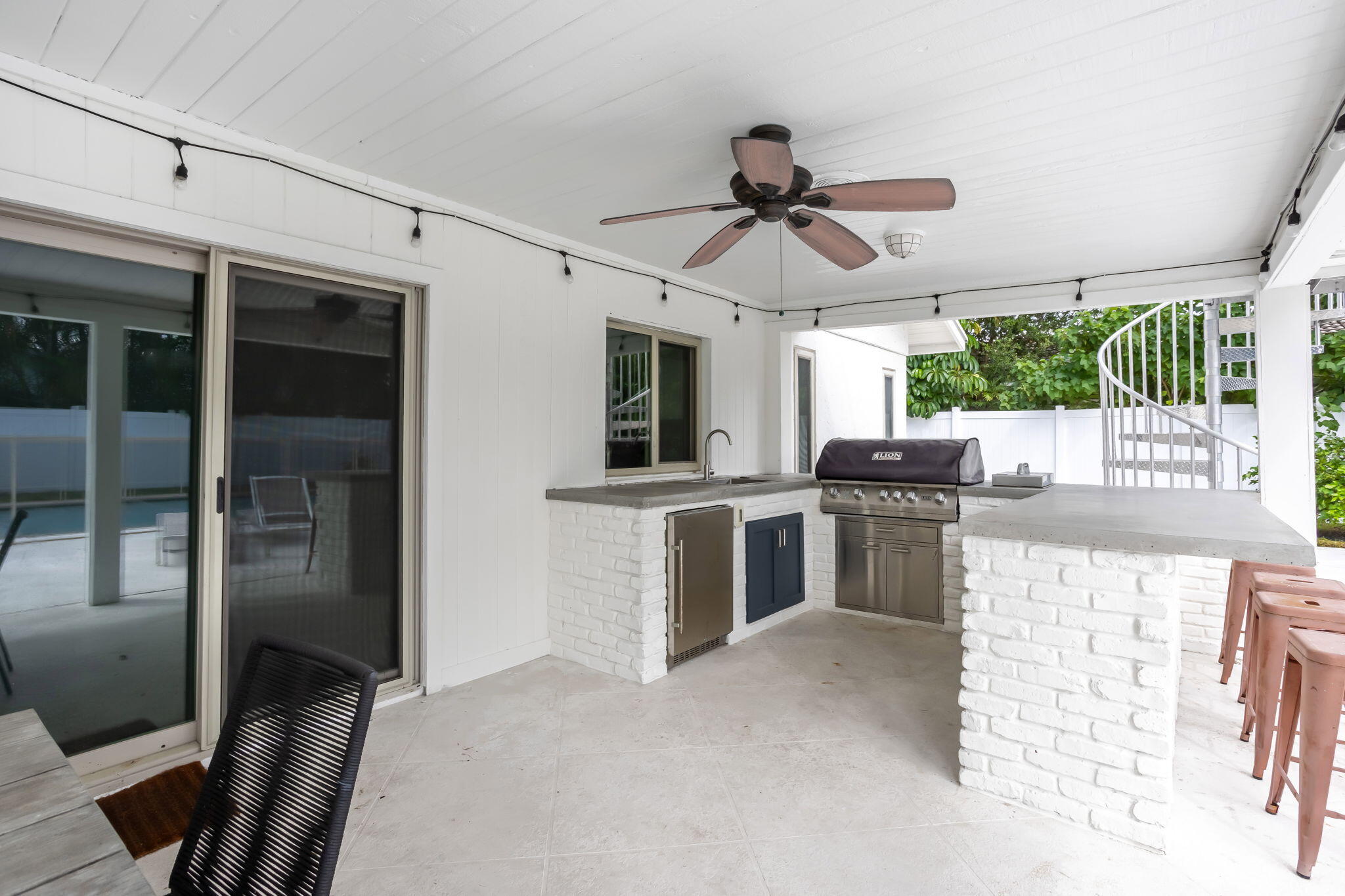 1260 Northwest 15th Street Boca Raton, FL 33486 - Photo 37 of 52 a kitchen with kitchen island stainless steel appliances a stove a sink and a refrigerator
