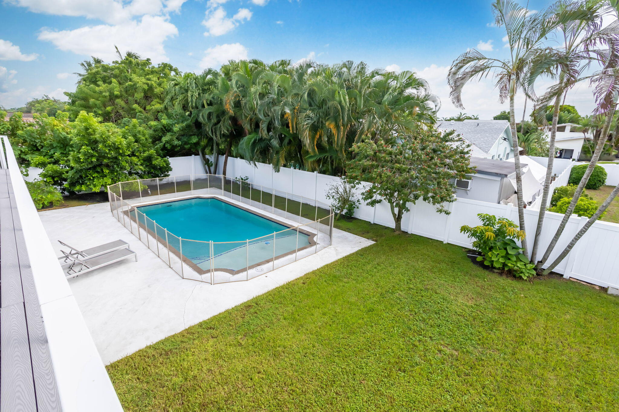 1260 Northwest 15th Street Boca Raton, FL 33486 - Photo 43 of 52 a view of a swimming pool with a yard