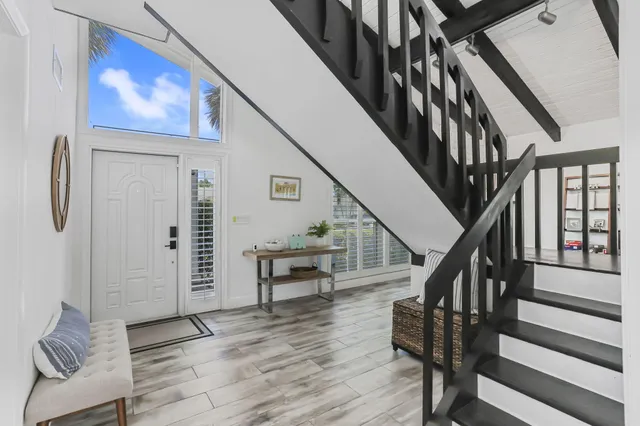 a view of entryway and hall with wooden floor