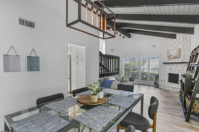 a large white kitchen with a large window