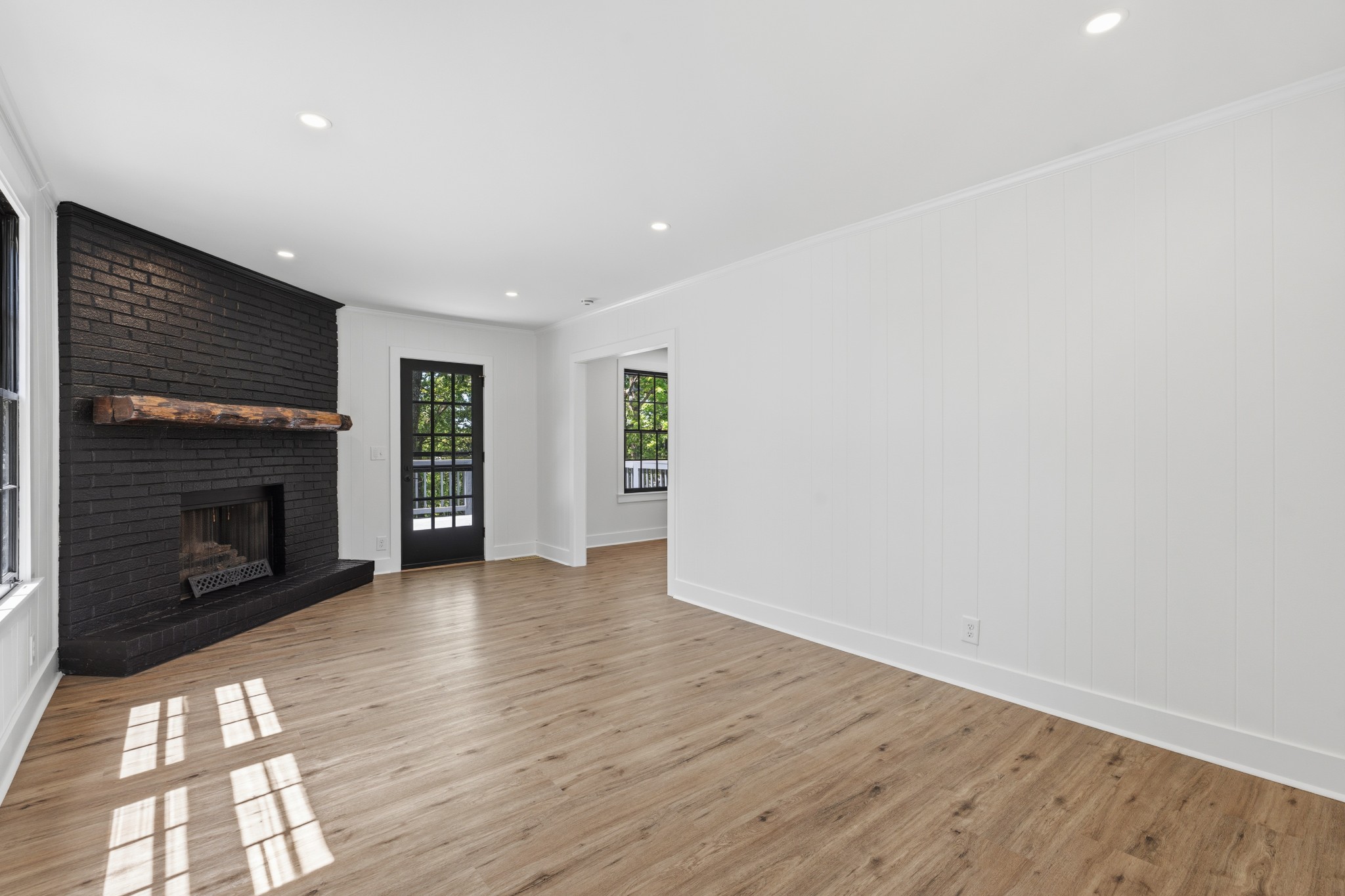 616 Baton Rouge Court Hermitage, TN 37076 - Photo 21 of 43 an empty room with wooden floor fireplace and windows