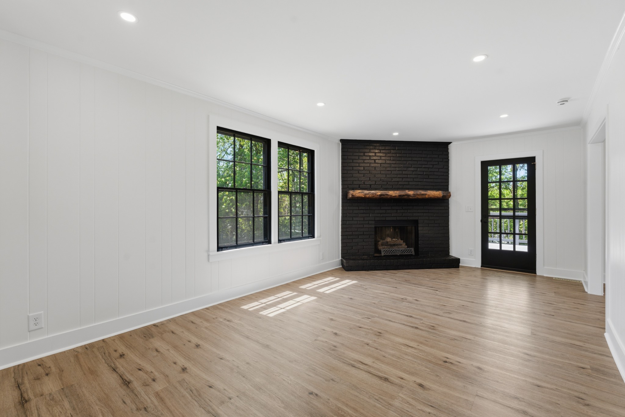 616 Baton Rouge Court Hermitage, TN 37076 - Photo 22 of 43 an empty room with wooden floor fireplace and windows
