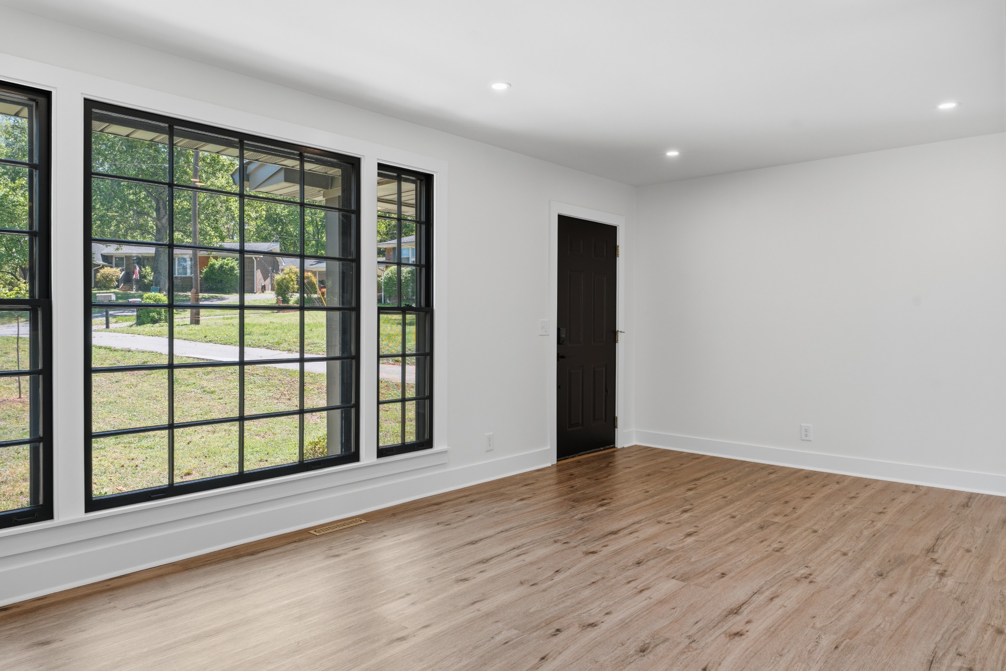 616 Baton Rouge Court Hermitage, TN 37076 - Photo 9 of 43 a view of an empty room with wooden floor and windows