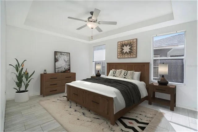 a spacious bedroom with a bed and a chandelier