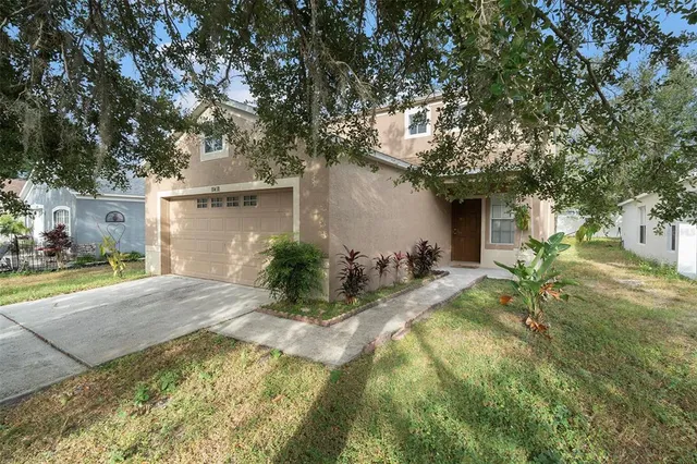 a view of backyard of house with green space