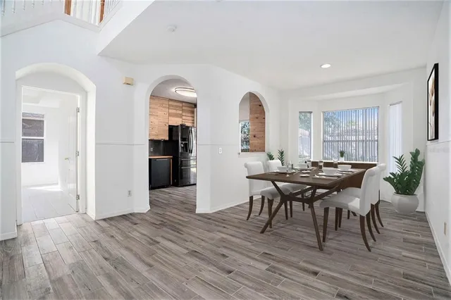 a view of a dining room with furniture and wooden floor