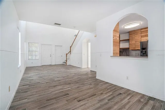 a view of a room with wooden floor and white walls