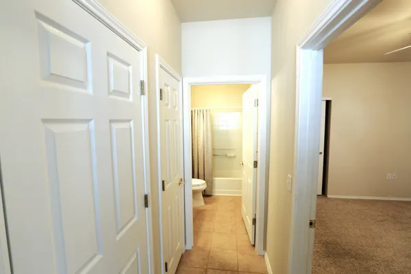a living room with patio furniture and a potted plants