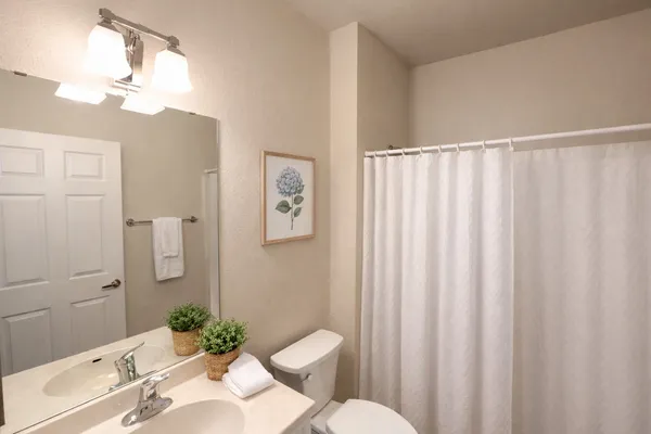 a view of a bathroom from a hallway