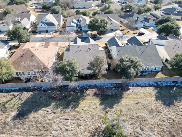 an aerial view of residential houses with outdoor space and swimming pool