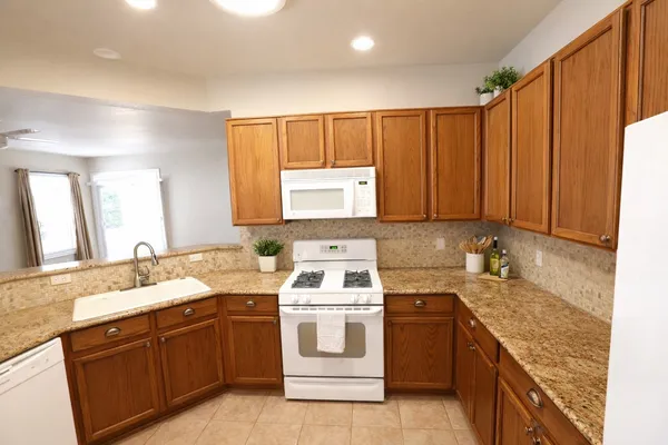 a kitchen with a refrigerator stove and sink