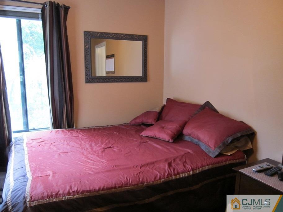 49 Park Gate Drive Edison, NJ 08820 - Photo 13 of 17 a bed sitting in a bedroom next to a window