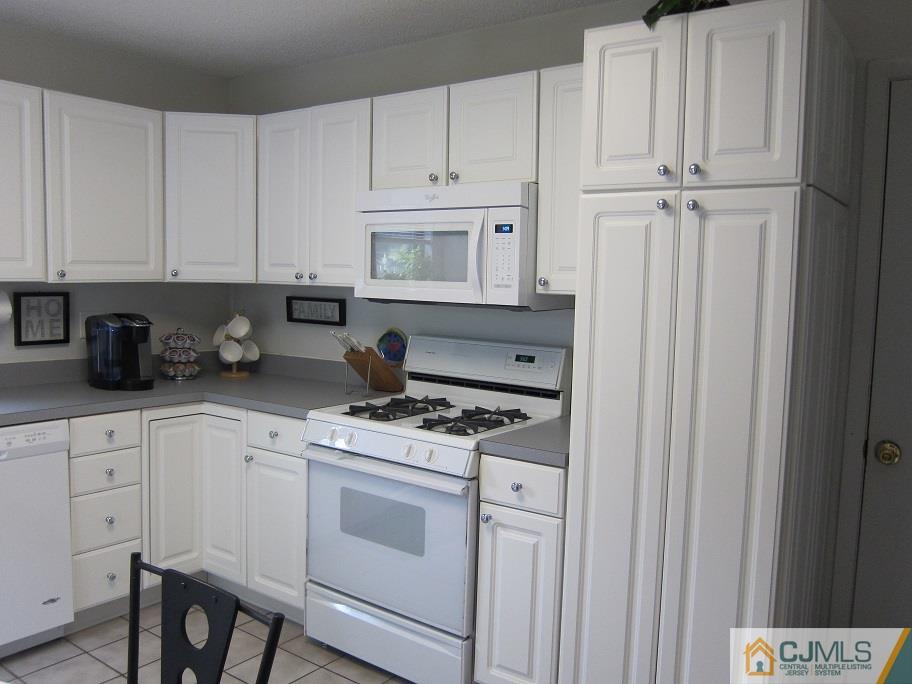 49 Park Gate Drive Edison, NJ 08820 - Photo 3 of 17 a kitchen with white cabinets and white appliances