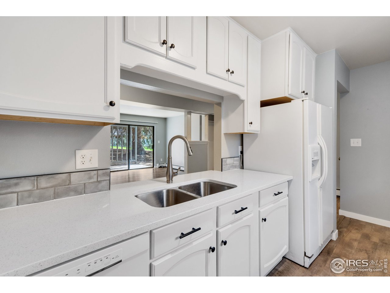 801 East Drake Road, Unit I69 Fort Collins, CO 80525 - Photo 3 of 27 Kitchen w/ Dining and Living Room Beyond