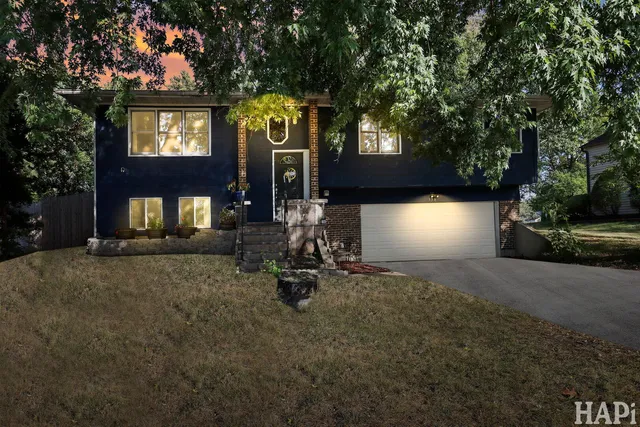a view of a house with a yard and tree s