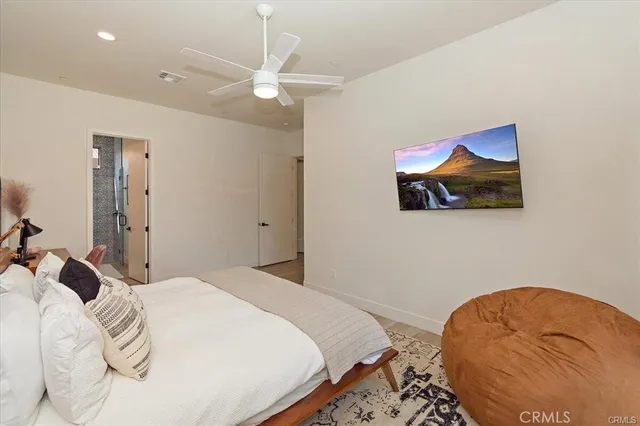 a bedroom with a bed and a painting on the wall