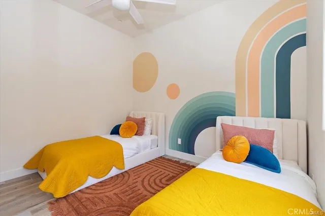 a bedroom with 2 bed and lamp