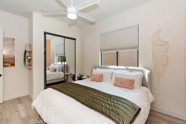 a bedroom with a bed and a mirror