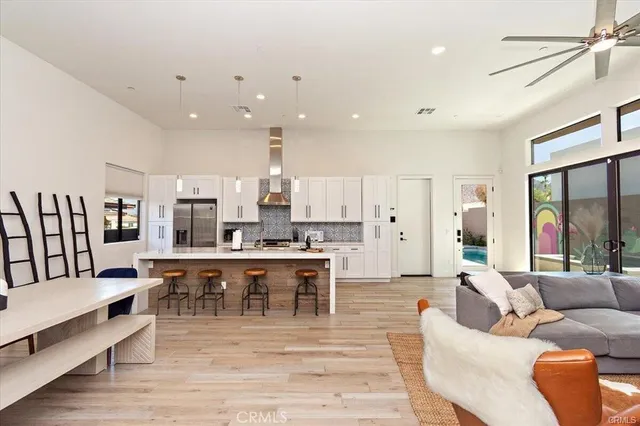a living room with lots of furniture and kitchen view