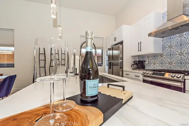 a kitchen with stainless steel appliances kitchen island granite countertop a refrigerator and a stove