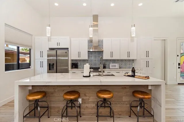a kitchen with granite countertop a table chairs stove and cabinets