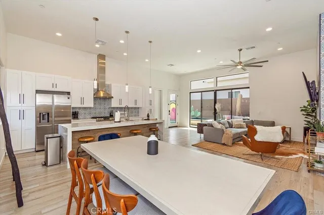 a large kitchen with kitchen island a large island a sink a stove and a refrigerator