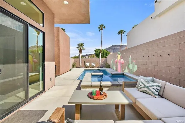 a living room with furniture and a floor to ceiling window