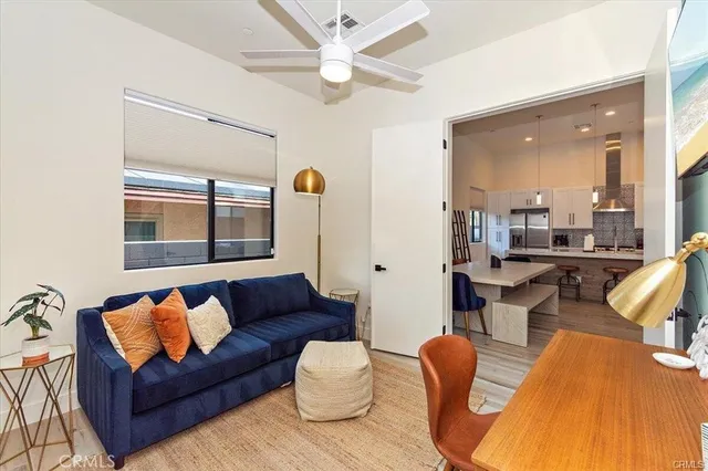 a living room with furniture a rug and a chandelier
