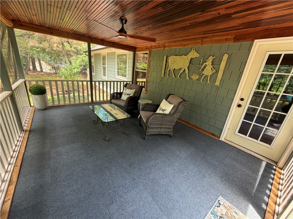 232 Hunters Trail Walhalla, SC 29691 - Photo 26 of 38 This inviting screened porch offers serene outdoor living amidst lush surroundings.