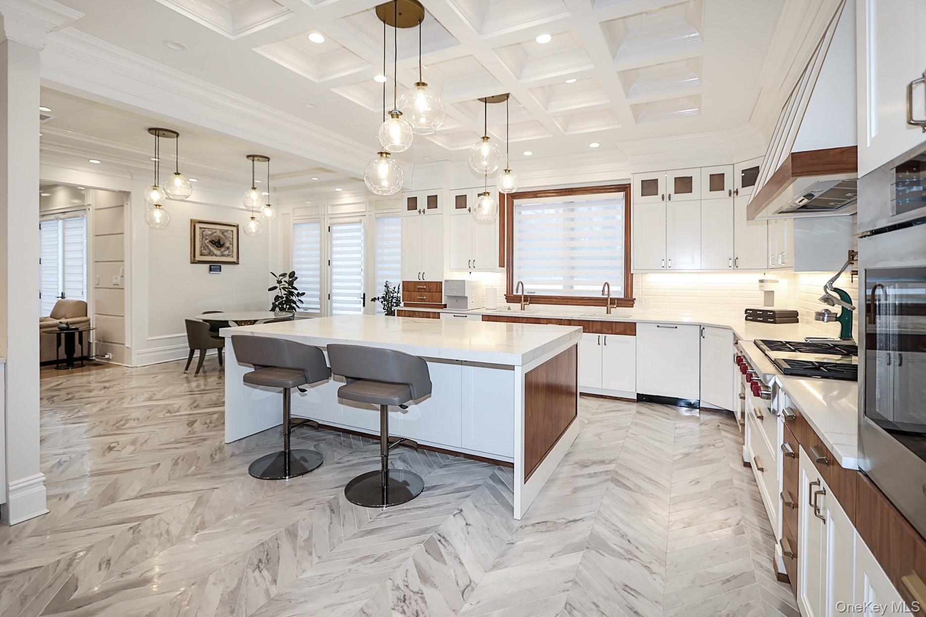 19 Gilbert Road Great Neck, NY 11024 - Photo 11 of 36 a large white kitchen with lots of counter space and furniture