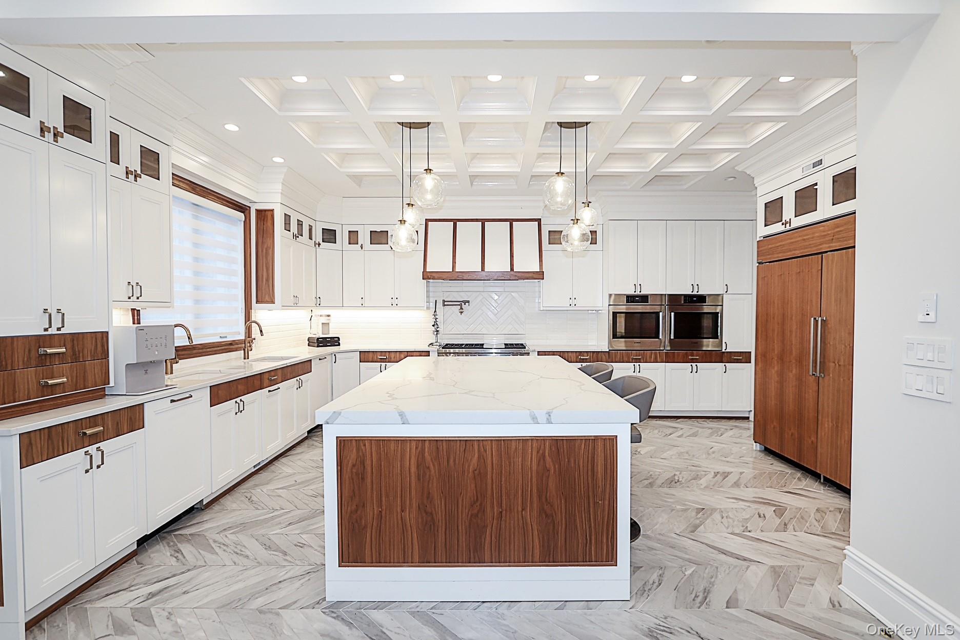 19 Gilbert Road Great Neck, NY 11024 - Photo 15 of 36 a large kitchen with stainless steel appliances kitchen island granite countertop a large counter top stainless steel appliances and cabinets