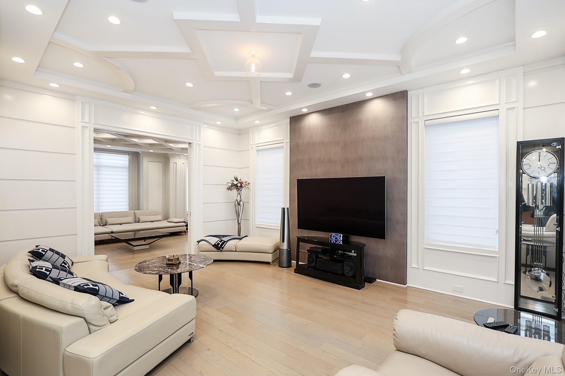 19 Gilbert Road Great Neck, NY 11024 - Photo 16 of 36 a living room with furniture and a flat screen tv