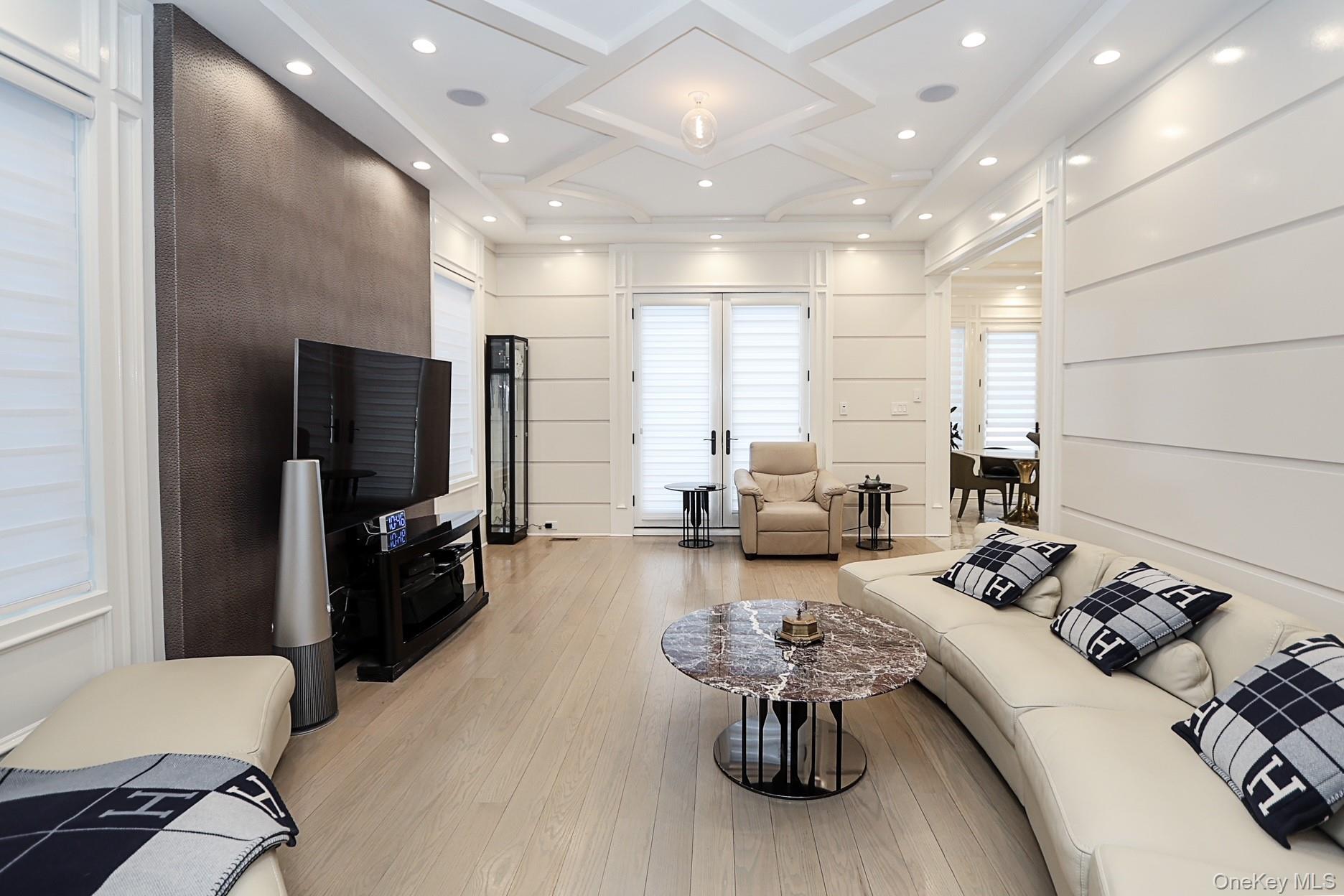 19 Gilbert Road Great Neck, NY 11024 - Photo 18 of 36 a living room with furniture and a flat screen tv