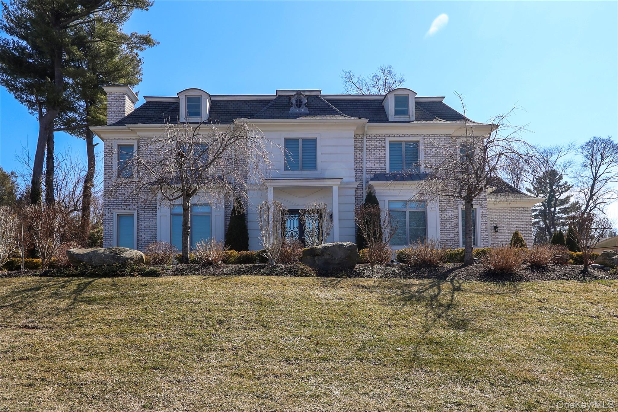19 Gilbert Road Great Neck, NY 11024 - Photo 2 of 36 a front view of a house with a yard