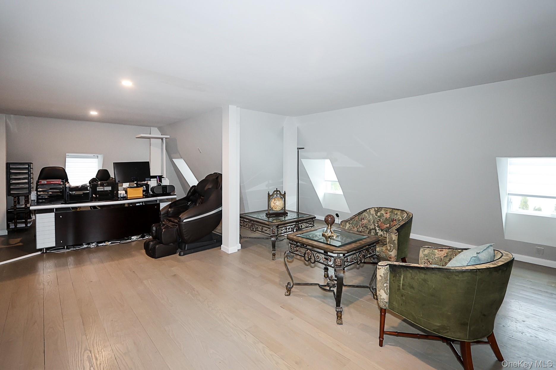 19 Gilbert Road Great Neck, NY 11024 - Photo 28 of 36 a living room with furniture and a wooden floor
