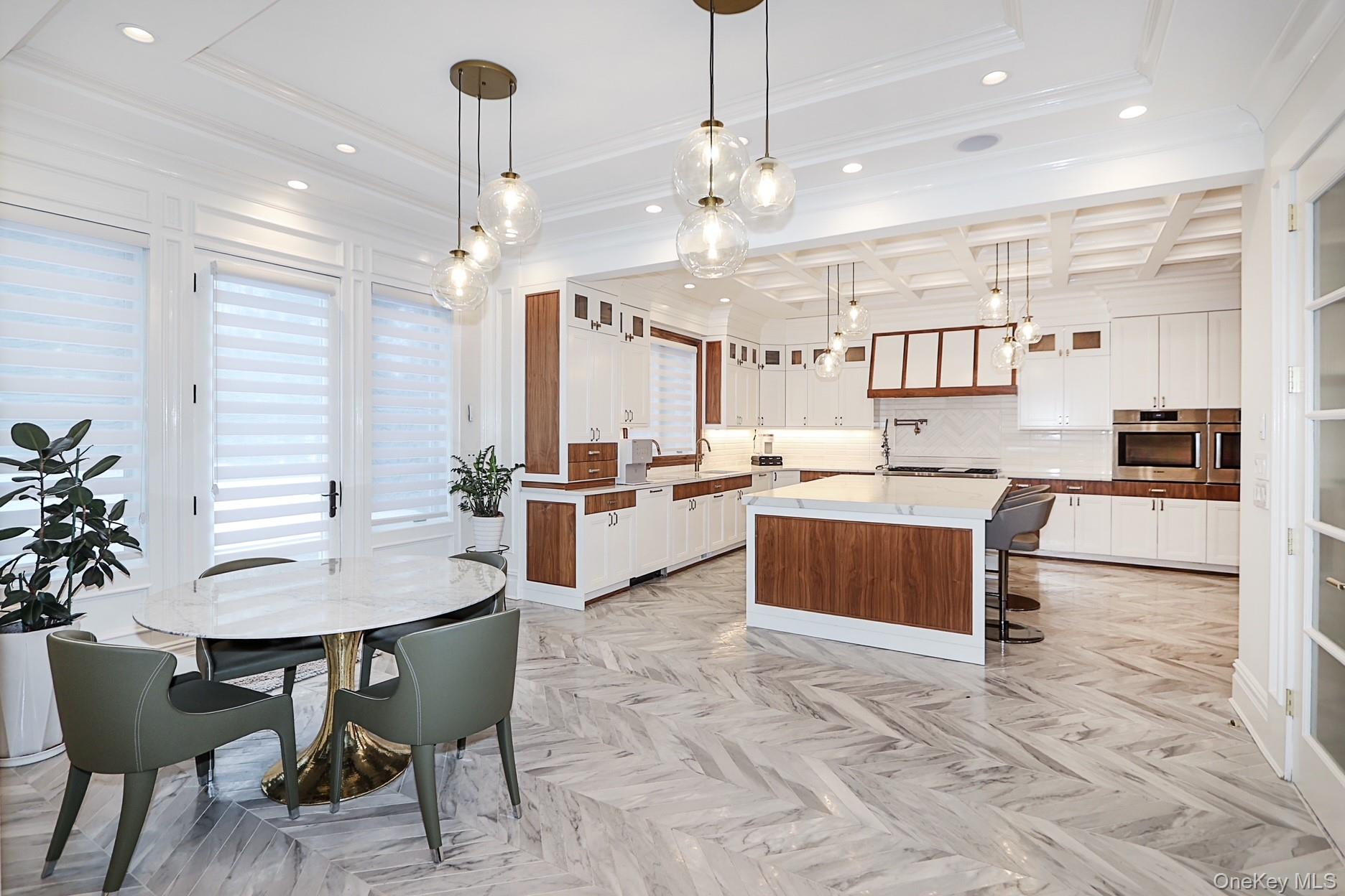 19 Gilbert Road Great Neck, NY 11024 - Photo 3 of 36 a open kitchen with stainless steel appliances kitchen island granite countertop a table chairs and a refrigerator
